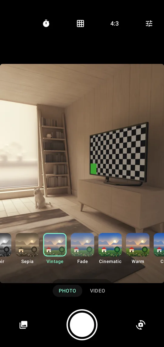 The mutaLens viewfinder showing a room, with a row of filter tiles along the bottom, each showing the same sample photograph under a different filter, and the shutter button below them.